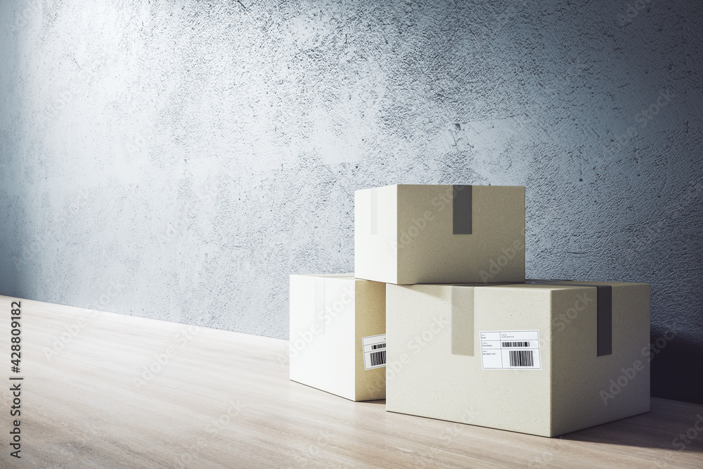 Poster delivery service and online shopping concept with three cardboard boxes with barcode on wooden floor