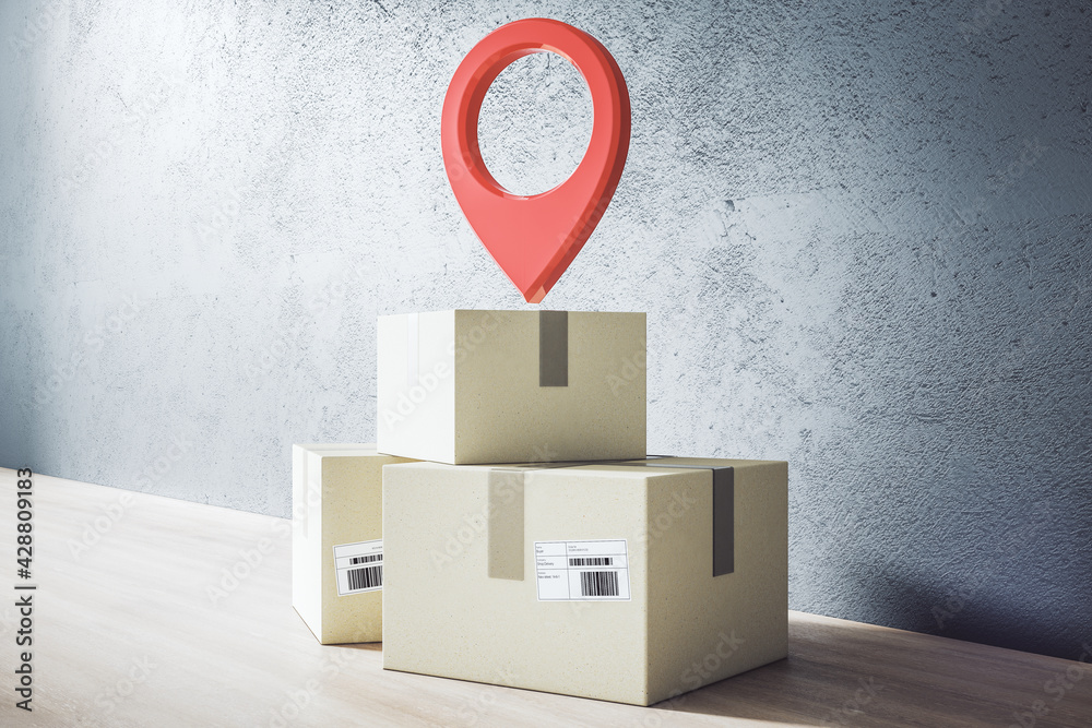 Poster delivery service concept with cardboard boxes and red pinpoint sign on wooden floor at concrete wall