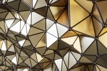 Perspective view on abstract futuristic style backdrop with golden volumetric glossy triangles, black lines and small balls