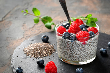 Healthy chia pudding with coconut milk and fresh berry in a glass