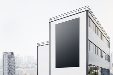 Vertical black outdoor billboard with copyspace on brick wall of modern building at blurry city background. 3D rendering, mock up