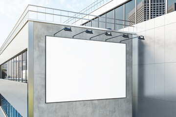 Blank white billboard in black frame with backlights on top on facade of business building in the morning. 3D rendering, mock up
