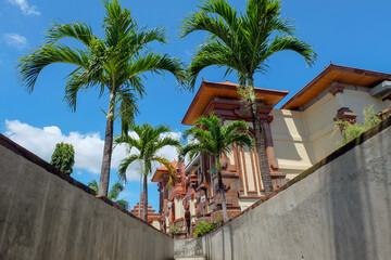 Kumbasari Market, Bali, Indonesia (April 2, 2021): A bridge between two traditional market in Denpasar city. The view of the traditional market building with the blue sky background. Shot from below.