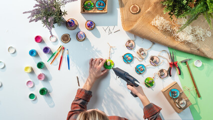 Top view of craftswoman making diy decorations, small business and desktop concept.