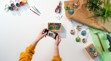 Top view of craftswoman making diy decorations, small business and desktop concept.