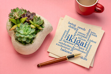 ikigai word cloud - interpretation of Japanese concept  - a reason for being as a balance between love, skills, needs and money - writing on a napkin with a cup of coffee