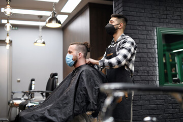 Man client visiting haidresser in barber shop, coronavirus and new normal concept.