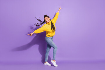 Fototapeta na wymiar Full size profile photo of optimistic funny brunette girl dance wear sweater jeans sneakers isolated on purple background
