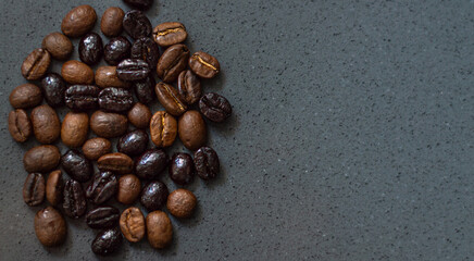Close-up of roasted coffee beans of different kinds on gray background with copy space. Wallpaper
