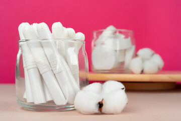 Glass jar with hygienic tampons and cotton flower