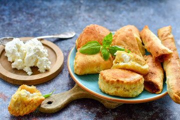 Fresh baked home made  Mini cheese puff pastries and cream  spread cheese.Cheese pie with phyllo pastry and herbs