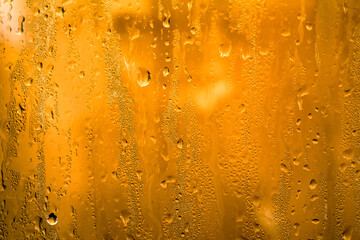 Waterdrop and condensed water vapor on the glass. Water running down the bathroom glass. 