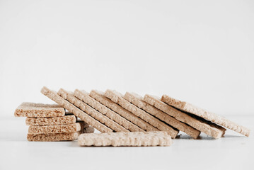 Stacked rye crisp bread on a white wooden background. Copy, empty space for text