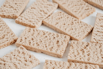 Rye crisp bread on a white wooden background. Top view. Copy, empty space for text
