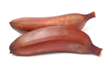 ripe tropical tasty red bananas on white background