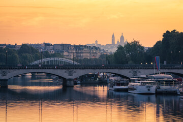 Paris, The Basilica of the Sacred Heart (Sacré-Cœur Basilica) and the Seine river at sunrise. Pont de Bir-Hakeim, Paris, France