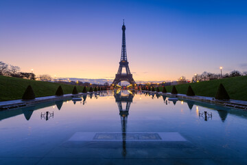 Fototapeta na wymiar Frozen reflections in Paris. Eiffel Tower at sunrise from Trocadero Fountains 