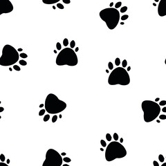 Fototapeta premium Seamless pattern with paws of animals in black on a white background.