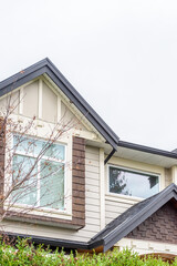 The top of the house or apartment building with nice window.