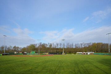 View of an empty baseball field from centerfield. Sky with light clouds.