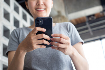 woman work using cell phone hand holding mobile texting message contact us.chatting,search internet information in office.technology device communication connecting