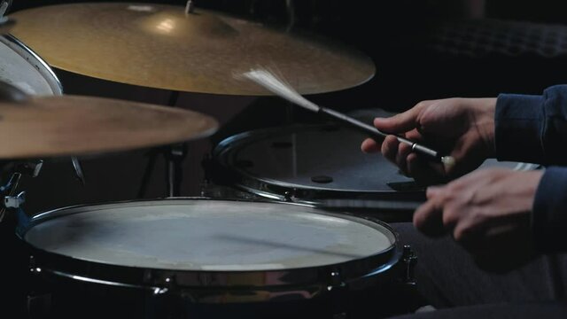 unrecognizable male jazz drummer playing at drums. isolated on black background. Close up shot. Home lesson training.