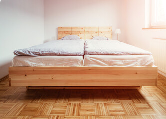 Stone pine bed: Empty wooden bed with pillow and blanket