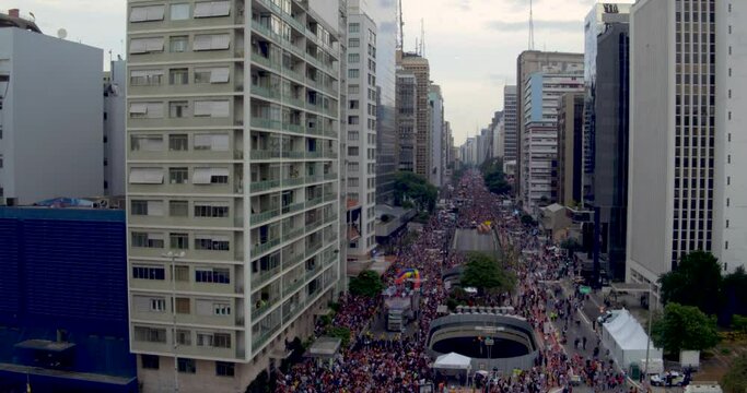 Gay Parade On Paulista Avenue During Sunset. Aerial Tilt Down