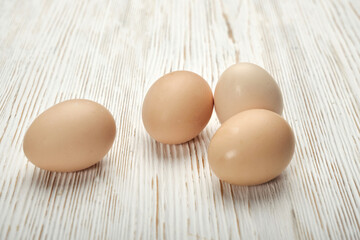Close-up view of raw chicken eggs in egg box on wooden background. Raw chicken eggs in egg box organic food for good health high protein .