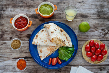 Close-up of Mexican quesadillas, with guacamole, tomatoes and spices