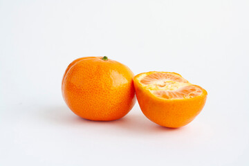 Tangerine whole and half on a white background