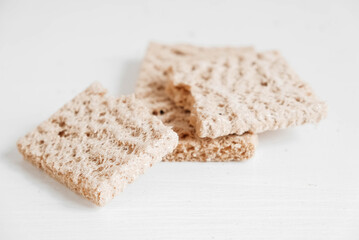 Rye crisp bread on a white wooden background. Top view. Copy, empty space for text