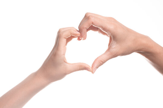 Heart shape created from kid and mother hands on white background. Love, happiness, parenthood, family, gesture concept. Close up