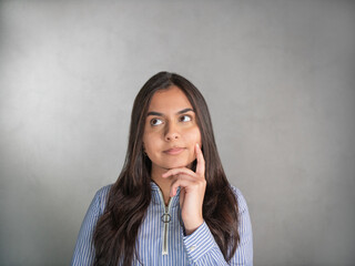 Close-up of a brown-haired woman's face in a blue striped jersey. Facial expression, questingly, in...