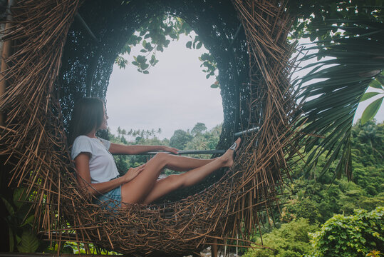 Beautiful girl having fun at the waterfalls in Bali. Concept about wanderlust traveling and wilderness culture