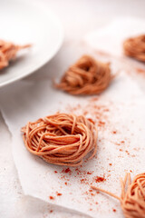 Homemade spaghetti with thyme and tomato flavor on a light concrete background