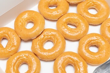 Top view Background of assorted glazed donuts in a box. Unhealthy food concept 