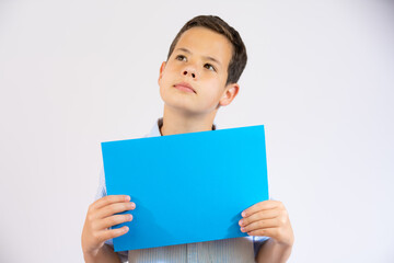 Cute boy holding blue blank paper isolated over white background