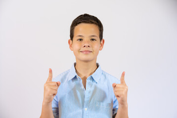 Cheerful smiling boy pointing up over white background
