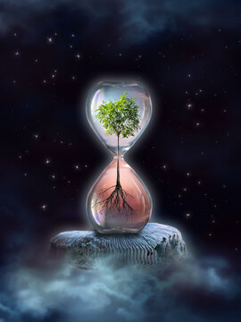 Earth Day or World Environment Day concept. Save our Planet and forest, restore and protect Green Nature, global warming and Climate change theme. Live and dry tree in Hourglass hovering in Space.