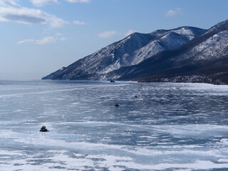 top view of the frozen Lake Baikal and the mountains on its shore. Siberia Russia