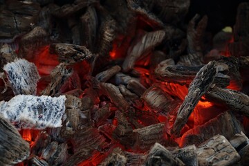 Embers smouldering in the flames of the fire