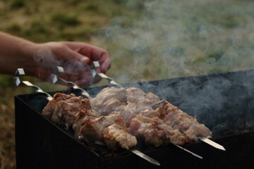 Meat is fried on skewers on the grill
