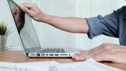 Work from home close up Asian businessman opening laptop computer typing information work planning strategy business finance, in quarantine lockdown coronavirus covid-19 pandemic, working home office - Powered by Adobe