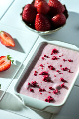 strawberry ice cream in a white container