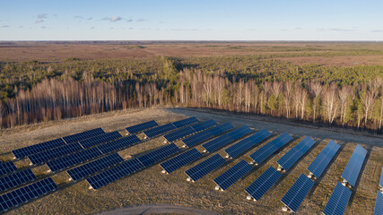 Aerial view to the solar farm built on top of the closed and restored garbage damp on the urban environment