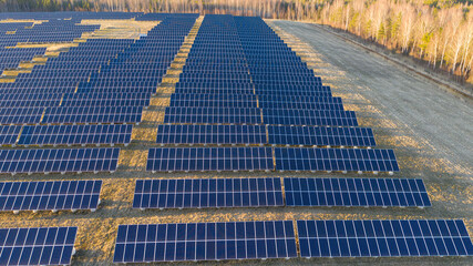 Aerial view to the solar farm built on top of the closed and restored garbage damp on the urban environment