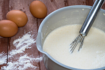 Cottage cheese and eggs on the table. Products for curd cakes. Cooking cottage cheese.