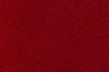 Textile background. Red velvet or corduroy. An empty and flat surface.