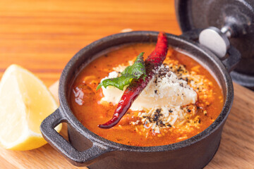 Traditional Mexican soup. Bowl spicy Mexican soup with a red chili garnish. Gourmet Mexican food
